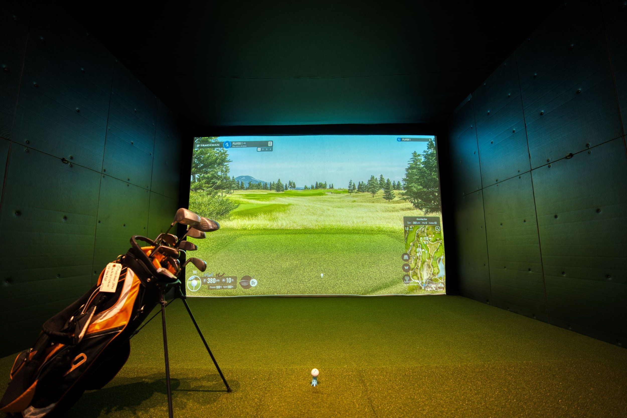 A modern indoor golf simulator with realistic course graphics, located in Mississauga, Canada.
